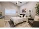 Cozy bedroom with a white bed, dark armchair, and farmhouse accents at 4600 Nebraska Ave, Sanford, FL 32771