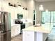 Modern kitchen with white cabinets, stainless steel appliances, and an island at 124 Cerise Ct, Daytona Beach, FL 32124