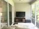 Screened lanai with tv and seating area at 124 Cerise Ct, Daytona Beach, FL 32124