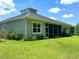 House exterior showcasing a screened-in porch and backyard at 124 Cerise Ct, Daytona Beach, FL 32124