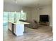 Open floor plan connecting kitchen to living room with a large sectional sofa at 124 Cerise Ct, Daytona Beach, FL 32124