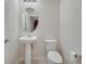 Small bathroom with pedestal sink and toilet at 5102 Caspian St, Saint Cloud, FL 34771