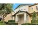 Two-story townhome with light beige and green exterior at 5102 Caspian St, Saint Cloud, FL 34771