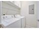Clean laundry room with washer, dryer, and overhead shelving at 5102 Caspian St, Saint Cloud, FL 34771