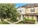 Two-story townhome with attractive landscaping and a welcoming front porch at 5102 Caspian St, Saint Cloud, FL 34771