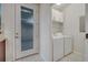 Bright laundry room with washer, dryer, and storage cabinets at 5102 Caspian St, Saint Cloud, FL 34771