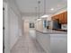 Open concept kitchen with island and views into the living room at 5102 Caspian St, Saint Cloud, FL 34771