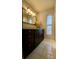 Bathroom with dark vanity and granite countertop at 5135 Warrior Ln, Kissimmee, FL 34746