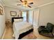 Bright bedroom with a queen-size bed and rocking chair at 5135 Warrior Ln, Kissimmee, FL 34746