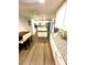 Bright kitchen with granite countertops, island, stainless steel appliances, and wood-look flooring at 5135 Warrior Ln, Kissimmee, FL 34746