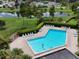 Community pool with lounge chairs and surrounding greenery at 5135 Warrior Ln, Kissimmee, FL 34746