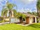 One-story home with palm trees and a landscaped lawn at 5135 Warrior Ln, Kissimmee, FL 34746
