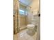 Bathroom with shower, toilet, and floral curtain at 5135 Warrior Ln, Kissimmee, FL 34746