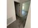 Hallway with grey wood-look floors and doors to other rooms at 14954 Sw 38Th Cir, Ocala, FL 34473
