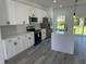 Modern kitchen with white cabinets and a large island at 14954 Sw 38Th Cir, Ocala, FL 34473