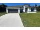 Modern home with gray garage door and green lawn at 14954 Sw 38Th Cir, Ocala, FL 34473