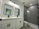 Bathroom with double vanity, grey tile, and shower at 14954 Sw 38Th Cir, Ocala, FL 34473