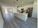 Open floor plan showcasing kitchen and living areas with luxury vinyl plank flooring at 14954 Sw 38Th Cir, Ocala, FL 34473