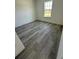 Bright bedroom with grey wood-look floors and a window at 14954 Sw 38Th Cir, Ocala, FL 34473