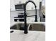 Modern kitchen sink with black faucet and white countertop at 14954 Sw 38Th Cir, Ocala, FL 34473