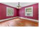 Simple bedroom with hardwood floors, window, and a chandelier at 1803 E Kaley Ave, Orlando, FL 32806