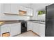 Small kitchen with white cabinets and black appliances at 1803 E Kaley Ave, Orlando, FL 32806