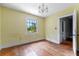 Bedroom with hardwood floors, window, and a chandelier at 1803 E Kaley Ave, Orlando, FL 32806