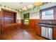 Vintage kitchen features wood cabinetry, built-in shelving, and a stainless steel dishwasher at 1803 E Kaley Ave, Orlando, FL 32806