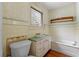 Bathroom with vintage tile, a tub, and pedestal sink at 1803 E Kaley Ave, Orlando, FL 32806