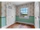 Small bedroom with hardwood floors, floral wallpaper, and a view at 1803 E Kaley Ave, Orlando, FL 32806
