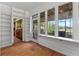 Sunroom with built-in shelves, hardwood floors, and a view of the water at 1803 E Kaley Ave, Orlando, FL 32806