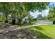 Side view of a house with a detached garage and a stone pathway at 1803 E Kaley Ave, Orlando, FL 32806