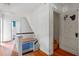 Upstairs hallway with hardwood floors and staircase to lower level at 1803 E Kaley Ave, Orlando, FL 32806
