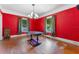 Spacious dining room with red walls, hardwood floors, and a chandelier at 1803 E Kaley Ave, Orlando, FL 32806