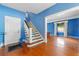 Staircase with blue and white painted risers and hardwood floors at 1803 E Kaley Ave, Orlando, FL 32806