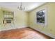 Bright bedroom with hardwood floors, window, and a chandelier at 1803 E Kaley Ave, Orlando, FL 32806