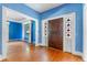 Entryway with hardwood floors, blue walls, and a stained glass door at 1803 E Kaley Ave, Orlando, FL 32806