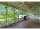 Screened porch with wooden flooring and ceiling fans at 1803 E Kaley Ave, Orlando, FL 32806