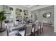 Elegant dining room features a large wooden table and statement wall art at 3443 Islewood Ct, Ocoee, FL 34761