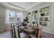 Bright dining room with a rustic wooden table and six chairs at 3443 Islewood Ct, Ocoee, FL 34761