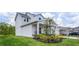 Two-story house with a front porch, landscaping, and a view of the neighborhood at 1105 Pacific Dunes Ct, Daytona Beach, FL 32124