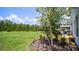 Landscaped backyard with a garden and trees at 1105 Pacific Dunes Ct, Daytona Beach, FL 32124