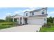 Two-story house with a front porch, attached garage, and landscaped lawn at 1105 Pacific Dunes Ct, Daytona Beach, FL 32124