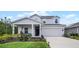 Two-story house with a front porch, driveway, and landscaping at 1105 Pacific Dunes Ct, Daytona Beach, FL 32124