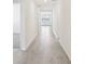 Long hallway with tile flooring and neutral-colored walls at 1748 Forest Run Ln, Auburndale, FL 33823