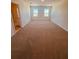 Large bedroom with two windows and carpeted floor at 3879 Malawi Trl, Saint Cloud, FL 34772