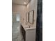 Double vanity bathroom with marble floors and a walk-in shower at 245 Little Brown Church Rd, Pierson, FL 32180