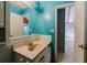 Bathroom with teal walls, a vanity, and a single sink at 1440 Walker Rd, Lakeland, FL 33810