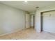Simple bedroom with light walls, tile floors and a closet at 1440 Walker Rd, Lakeland, FL 33810