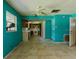 View of a kitchen needing updates, featuring teal walls and tile flooring at 1440 Walker Rd, Lakeland, FL 33810